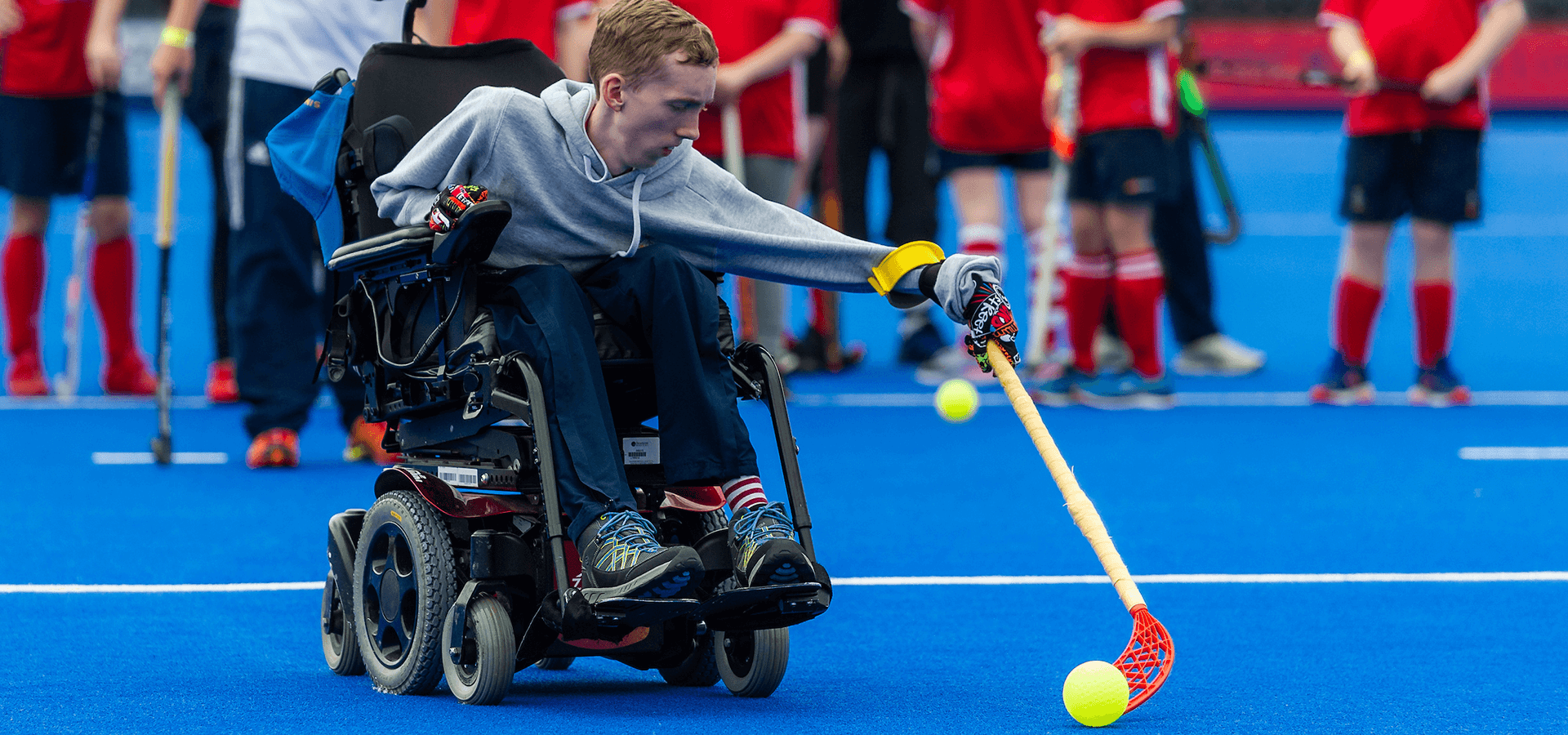 Boy in wheelchair playing hockey