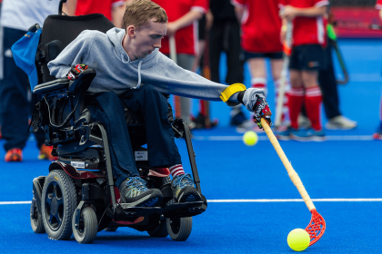 Boy in wheelchair playing hockey