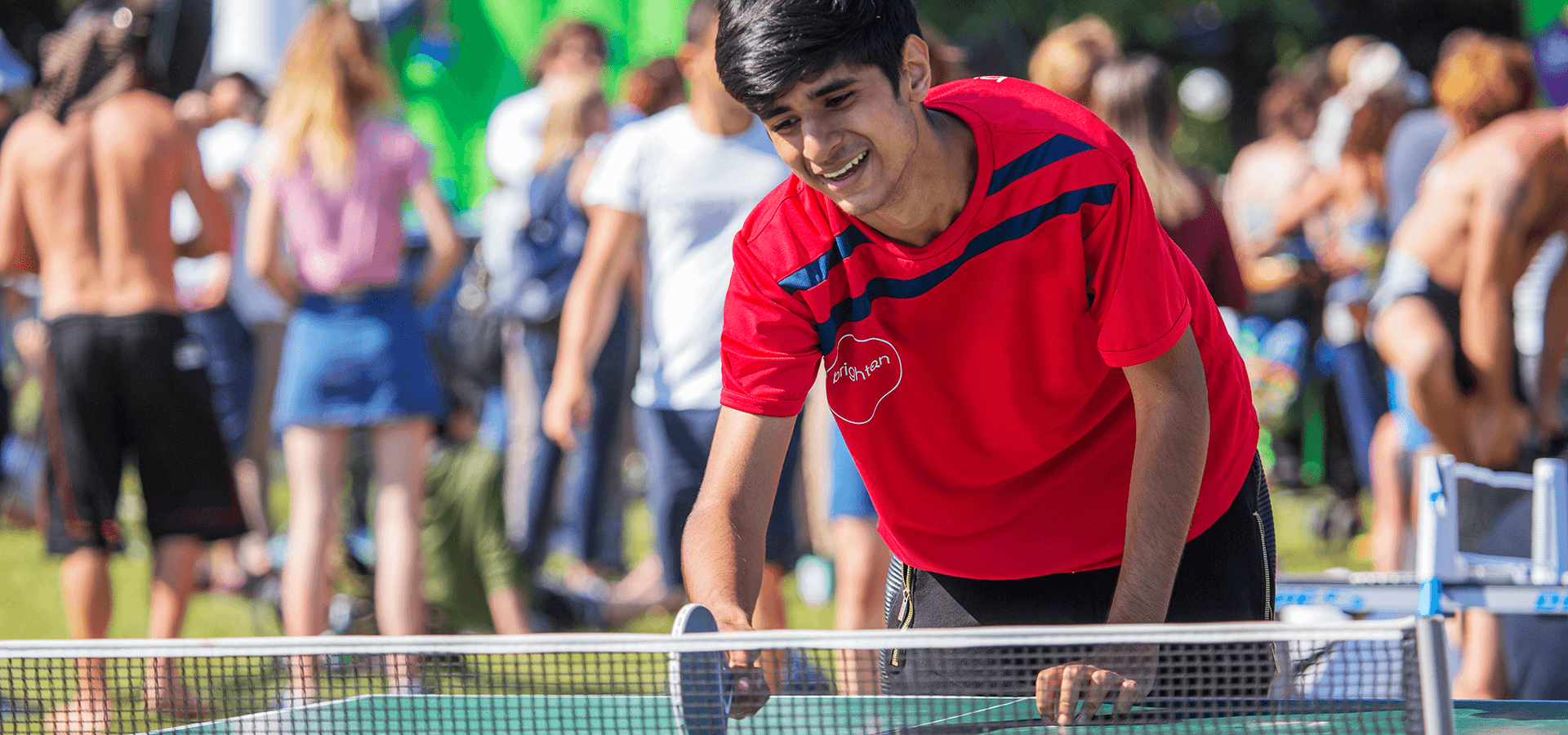 boy playing table tennis at the net