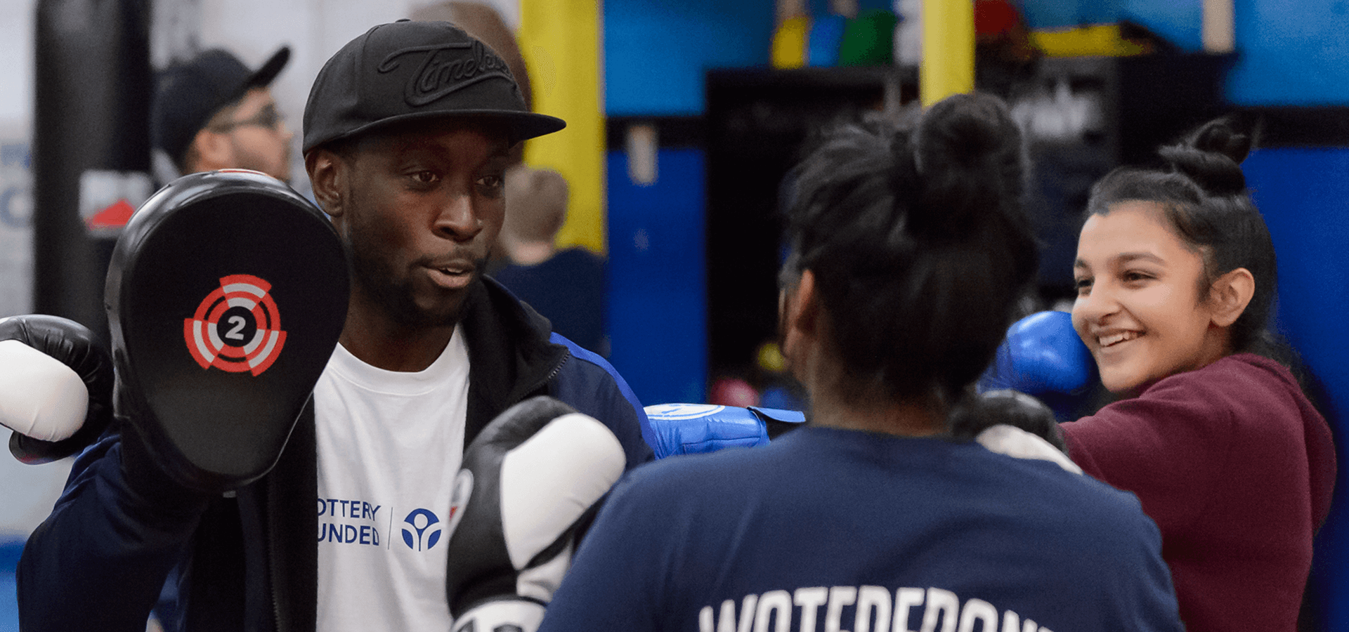 Coach teaching young girl boxing