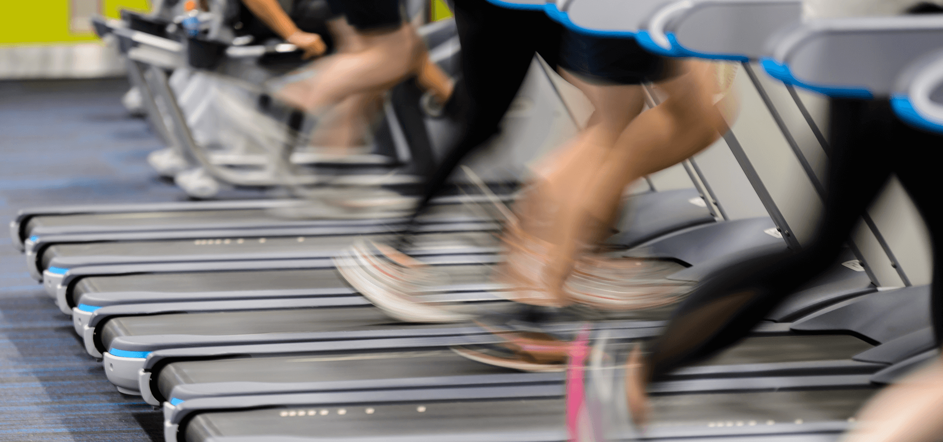 People running on treadmill in gym